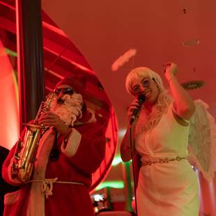 Weihnachtsmann Saxophon mit seinem Engel Weihnachtsfeier Musikprogramm