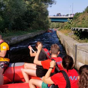 Rudernde Menschen in einem Raftingboot