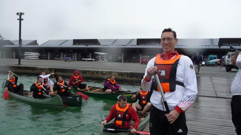 Andreas Dittmer steht auf dem Steg, im Wasser sind Gäste in den Booten.