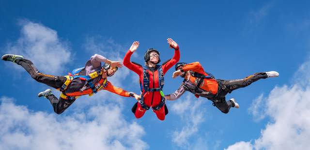 3 Personen beim Fallschirmsprung